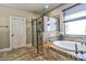 A luxurious bathroom features a soaking tub, walk-in shower, and modern tilework at 1704 Via Palermo St, Plant City, FL 33566