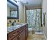 Well-lit bathroom showcasing a vanity, granite countertop, tiled floors, and bathtub at 1704 Via Palermo St, Plant City, FL 33566