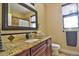 Well-lit bathroom features granite countertop, cherry wood vanity, and decorative backsplash at 1704 Via Palermo St, Plant City, FL 33566