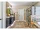 Bathroom with a walk-in shower, soaking tub, and vessel sinks set in stylish cabinets at 1704 Via Palermo St, Plant City, FL 33566