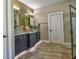 Bathroom featuring double vessel sinks, tile accents, and sleek black cabinets at 1704 Via Palermo St, Plant City, FL 33566