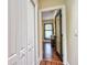 Hallway view into bedroom with dark wood floors and natural light at 1704 Via Palermo St, Plant City, FL 33566