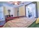 The bedroom showcases dark wood floors and a modern ceiling fan at 1704 Via Palermo St, Plant City, FL 33566