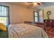 This bedroom features wood flooring and a ceiling fan for added comfort at 1704 Via Palermo St, Plant City, FL 33566