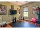 This home gym features hard wood floors and workout equipment at 1704 Via Palermo St, Plant City, FL 33566