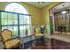 Bright living room with hardwood floors, decorative chairs, and arched window at 1704 Via Palermo St, Plant City, FL 33566