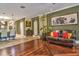 Open floor plan living room with tile flooring and a comfortable leather couch at 1704 Via Palermo St, Plant City, FL 33566