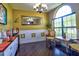 Bright living room with hardwood floors, elegant chairs, and natural lighting at 1704 Via Palermo St, Plant City, FL 33566