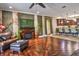 Inviting living room featuring a fireplace, detailed wood floors, and seamless access to the kitchen at 1704 Via Palermo St, Plant City, FL 33566