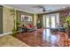 Spacious living area with hardwood floors, stone accent wall and access to the outdoor living at 1704 Via Palermo St, Plant City, FL 33566