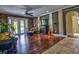 An open living area with unique wood flooring, fireplace, and access to the pool and bathroom at 1704 Via Palermo St, Plant City, FL 33566