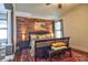 Cozy main bedroom showcases a wood accent wall, bedside lamps, and an adjacent luxury bathroom at 1704 Via Palermo St, Plant City, FL 33566