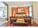 Bright and airy main bedroom featuring a wood accent wall and an adjacent luxury bathroom at 1704 Via Palermo St, Plant City, FL 33566