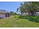 A lush, green backyard providing ample space for outdoor activities and relaxation, with mature trees at 1802 Bedford Ter # 187, Sun City Center, FL 33573