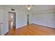 Spacious bedroom with hardwood floors, ceiling fan, and closet storage at 1802 Bedford Ter # 187, Sun City Center, FL 33573