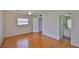 Bedroom featuring wood flooring, closet, ceiling fan, and access to the bathroom at 1802 Bedford Ter # 187, Sun City Center, FL 33573