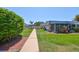 Community courtyard featuring meticulously maintained green spaces, lush landscaping and well-lit walkways at 1802 Bedford Ter # 187, Sun City Center, FL 33573