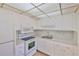 The kitchen showcases white appliances, ample cabinet space, and efficient layout at 1802 Bedford Ter # 187, Sun City Center, FL 33573