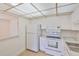 Efficient kitchen showcasing white appliances and cabinetry at 1802 Bedford Ter # 187, Sun City Center, FL 33573