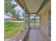 View from a screened lanai onto the green lawn and landscaping at 1802 Bedford Ter # 187, Sun City Center, FL 33573