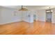 Open-concept living room features hardwood floors, ceiling fan and seamless flow to the kitchen at 1802 Bedford Ter # 187, Sun City Center, FL 33573