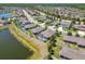 Aerial view features a backyard pool with screened enclosure and community lake views at 18796 Obregan Dr, Spring Hill, FL 34610