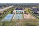 Aerial view of the community pool, tennis and basketball courts, and playground at 18796 Obregan Dr, Spring Hill, FL 34610