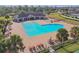 An aerial view of the community pool, patio, palm trees, and outdoor seating at 18796 Obregan Dr, Spring Hill, FL 34610