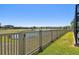 Backyard with a white fence and a scenic view of the pond, offering privacy and tranquility at 18796 Obregan Dr, Spring Hill, FL 34610