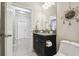Bathroom with granite countertop, dark cabinetry, neutral wall color, and modern fixtures at 18796 Obregan Dr, Spring Hill, FL 34610