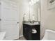 Modern bathroom features granite countertop, black cabinet, and tile floors at 18796 Obregan Dr, Spring Hill, FL 34610