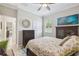 Bedroom view showing closet, ceiling fan, and accent cabinet along with bright decor at 18796 Obregan Dr, Spring Hill, FL 34610