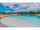 Large community pool with a beach-like entry and spacious deck for residents to enjoy at 18796 Obregan Dr, Spring Hill, FL 34610