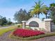 Talavera community entrance sign featuring colorful landscaping, mature trees and stone accents at 18796 Obregan Dr, Spring Hill, FL 34610