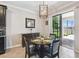 Cozy dining area features a modern chandelier and sliding glass doors to the patio at 18796 Obregan Dr, Spring Hill, FL 34610