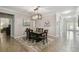 Bright dining room with elegant chandelier and neutral color palette at 18796 Obregan Dr, Spring Hill, FL 34610