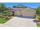 Attractive single-story home with a spacious driveway, manicured lawn, and well-maintained landscaping at 18796 Obregan Dr, Spring Hill, FL 34610