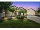 Charming single-story home with stone accents, manicured lawn, and lush landscaping at dusk at 18796 Obregan Dr, Spring Hill, FL 34610