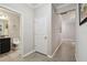 Hallway leads to bathroom with granite counters and gray cabinets at 18796 Obregan Dr, Spring Hill, FL 34610