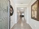 Bright and airy hallway with tiled flooring, crown molding, and decorative accents at 18796 Obregan Dr, Spring Hill, FL 34610