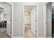 Hallway view of bathroom and bonus room featuring neutral walls, tile flooring, and white doors at 18796 Obregan Dr, Spring Hill, FL 34610