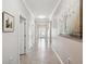Well-lit hallway featuring neutral paint, tile floors, and ample wall space for decor at 18796 Obregan Dr, Spring Hill, FL 34610