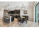 Modern kitchen with dark cabinetry, stainless steel appliances, and a breakfast bar for casual dining at 18796 Obregan Dr, Spring Hill, FL 34610
