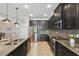 Well-equipped kitchen with stainless steel appliances, granite countertops, and dark cabinetry at 18796 Obregan Dr, Spring Hill, FL 34610