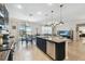 Modern kitchen with granite countertops, stainless steel appliances, and island seating at 18796 Obregan Dr, Spring Hill, FL 34610