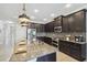 Stylish kitchen with granite countertops, stainless steel appliances, and dark wood cabinets at 18796 Obregan Dr, Spring Hill, FL 34610