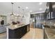 Modern kitchen features a large island, granite countertops, and stainless steel appliances at 18796 Obregan Dr, Spring Hill, FL 34610