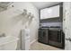 Well-equipped laundry room with modern appliances and storage shelves at 18796 Obregan Dr, Spring Hill, FL 34610