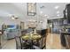 Open-concept living room with modern gray couch and open flow to the kitchen with stainless steel appliances at 18796 Obregan Dr, Spring Hill, FL 34610