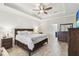 Spacious main bedroom featuring a tray ceiling, ceiling fan, and shiplap accent wall at 18796 Obregan Dr, Spring Hill, FL 34610